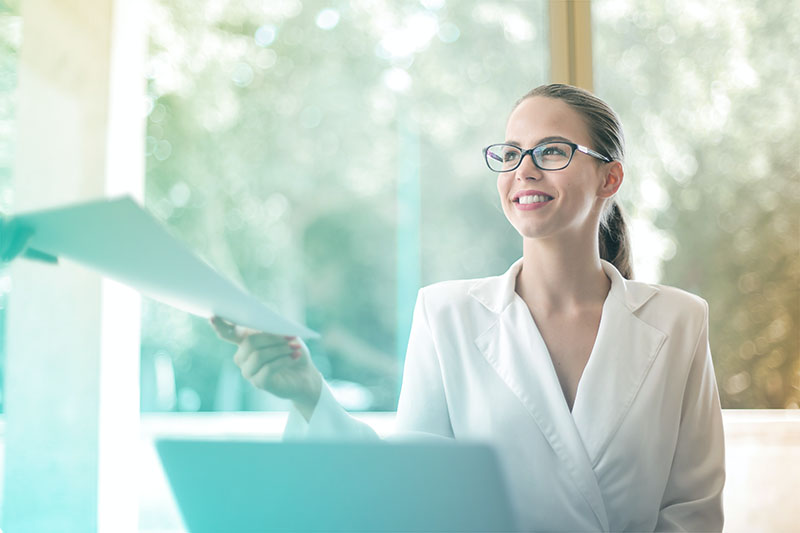 Business woman handing report to coworker