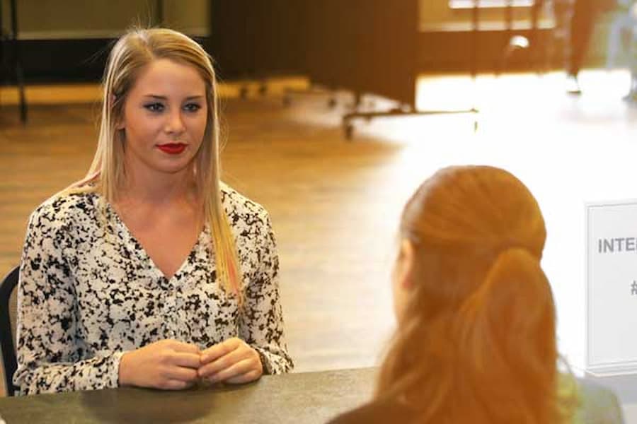 student talking with staff member