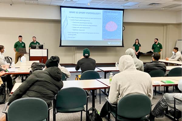 Students work with Green Bay Blizzard football team