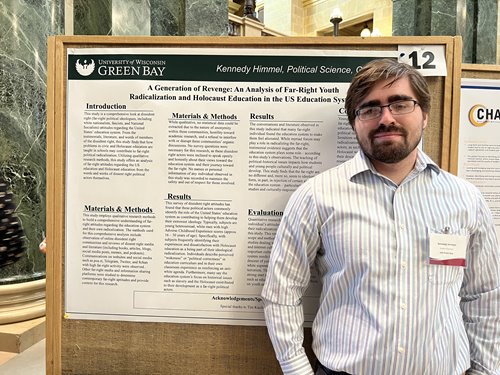 Student standing by project