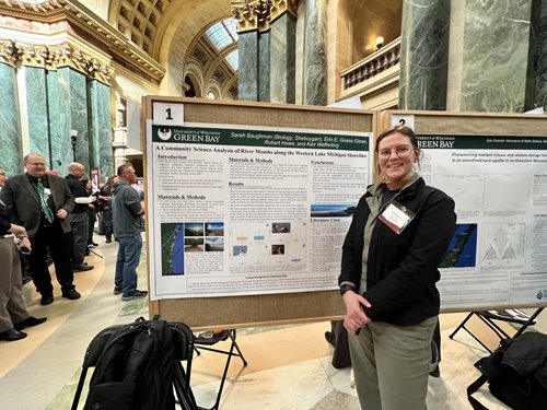 Student standing by project