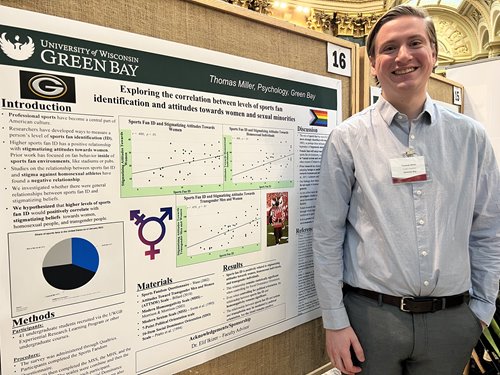 Student standing by project