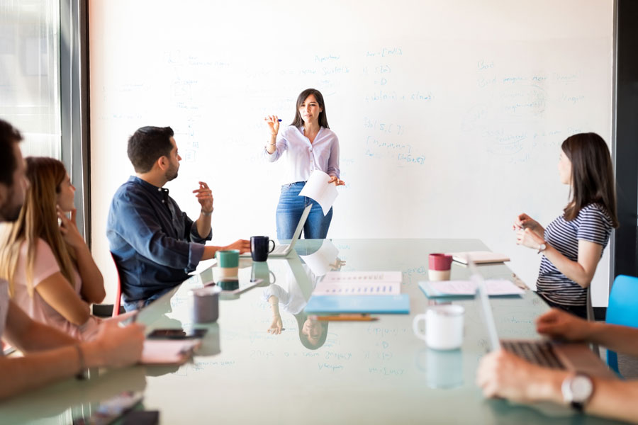 Female leads meeting with emergency management coworkers