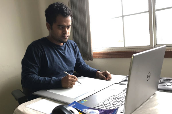 Person working from home with a tablet and stylus