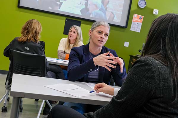 women talking in small groups during advanced leadership class