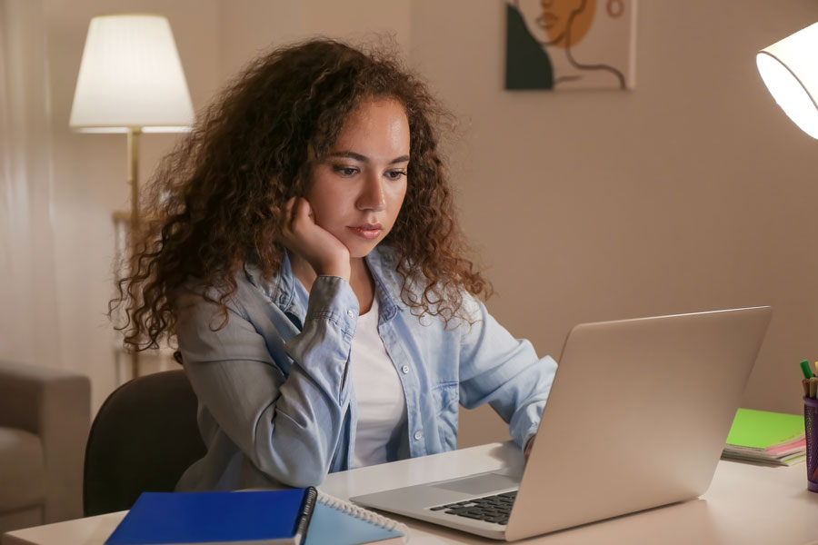 Female studies at laptop
