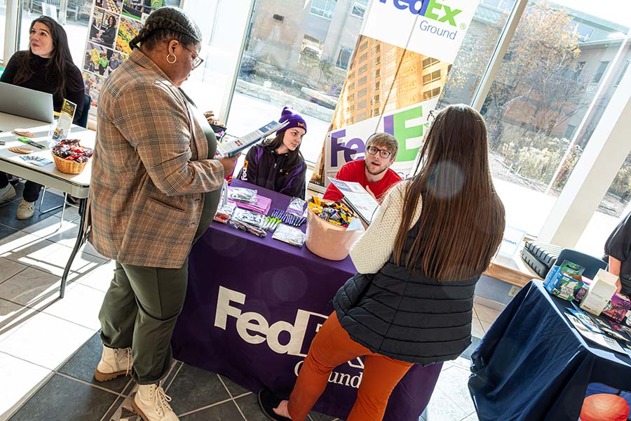 students talking to employer during Learning While Earning event
