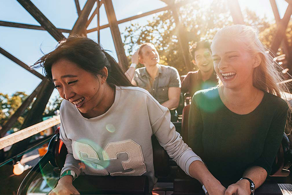 photo of young adults on a rollercoaster