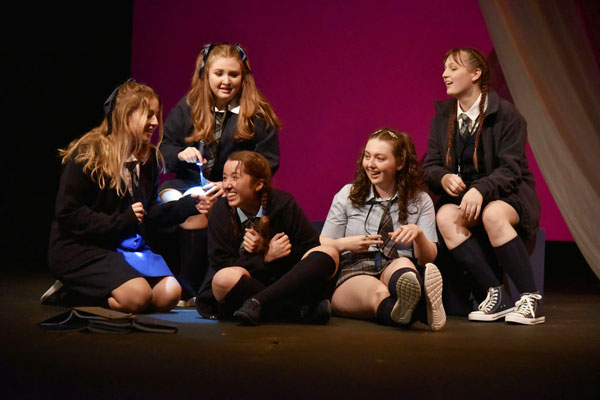 Group of female students perform in the program Red
