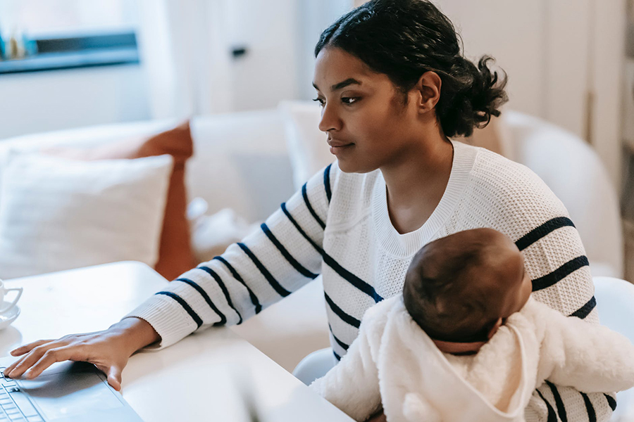 African American female holds infant
