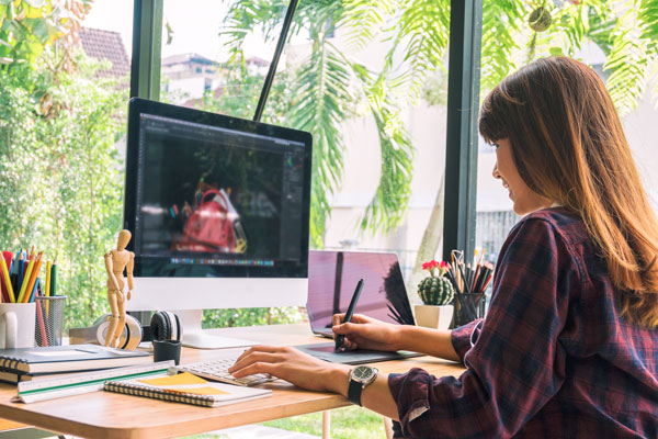 Female works on computer from home