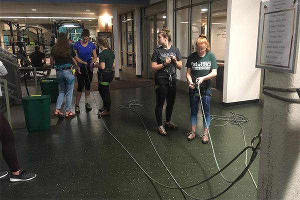 Clinic participants getting top-rope belay trained