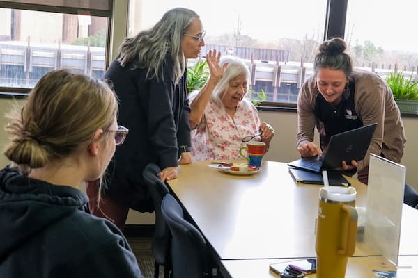 Elder Coral speaks with students and peers