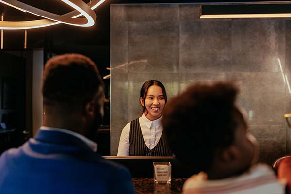 hotel front desk worker helping guests