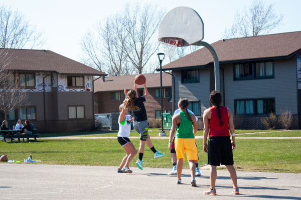 Students playing outdoor intramural basketball