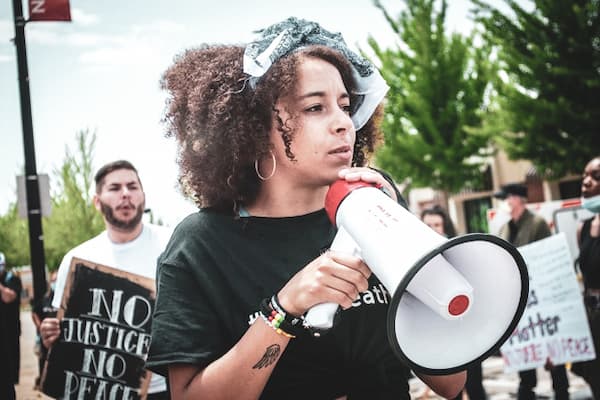 Hannah Beauchamp Pope holds megaphone at rally