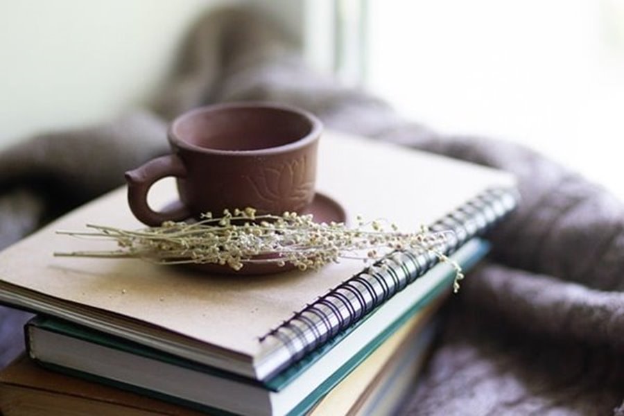Coffee cup on stack of books