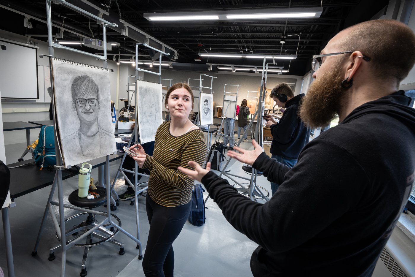 Student showing an art piece.