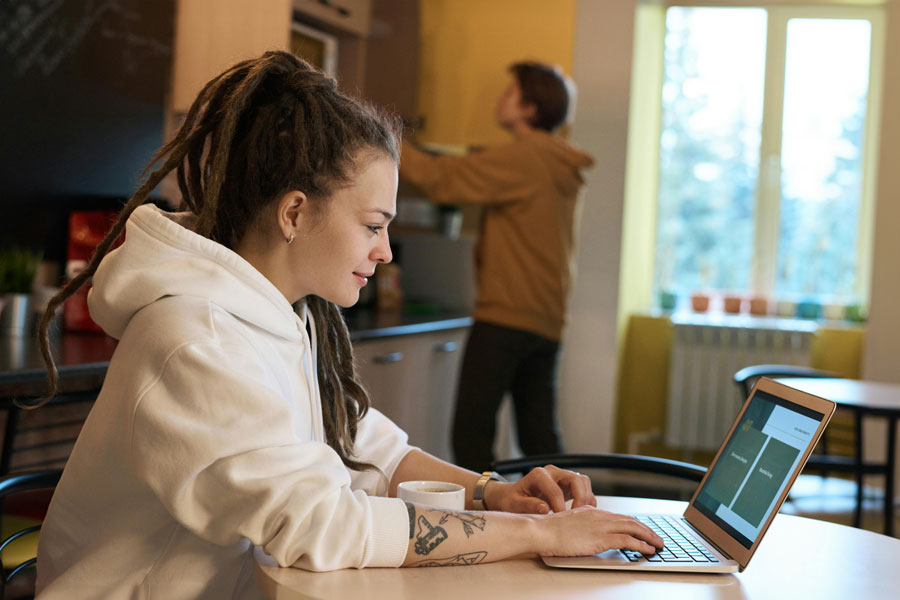 Online student working on laptop at home