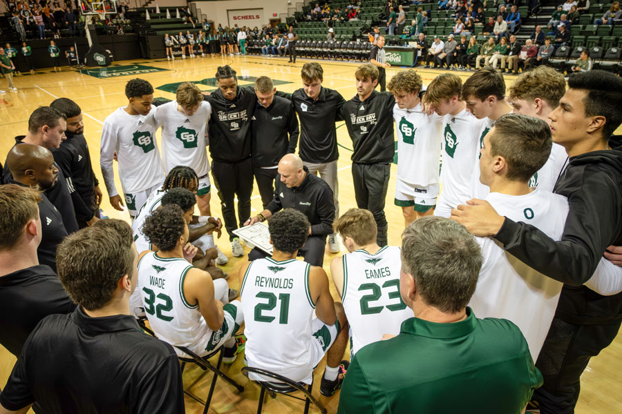 UW-Green Bay Men's Basketball Team huddle together before game
