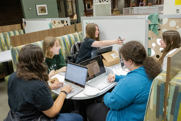 Group of students studying around table
