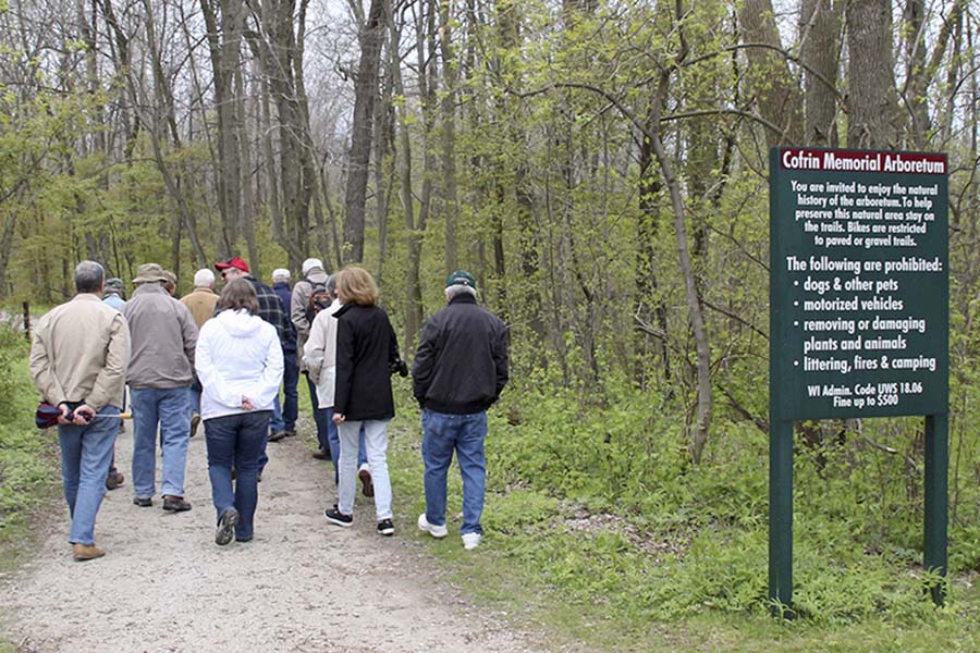 A group of people walking on a campus trail